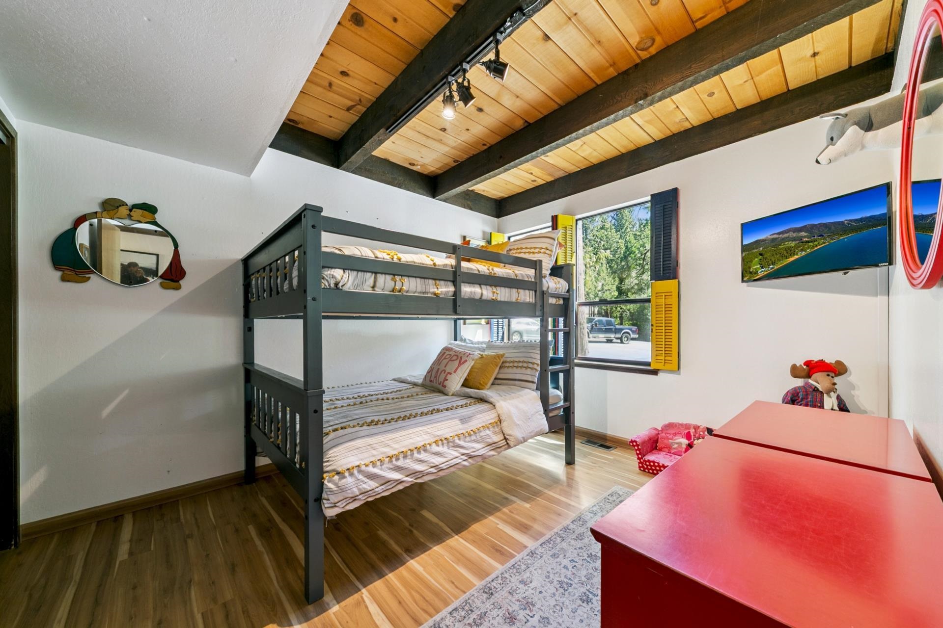 1001 Commonwealth Drive, Unit 114 Kings Beach, CA 96143 - Photo 16 of 23 a bedroom with a bed and wooden floor