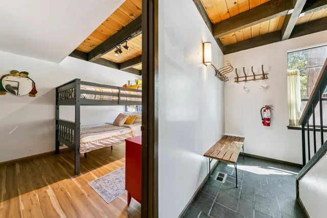 a hallway with a table and a potted plant