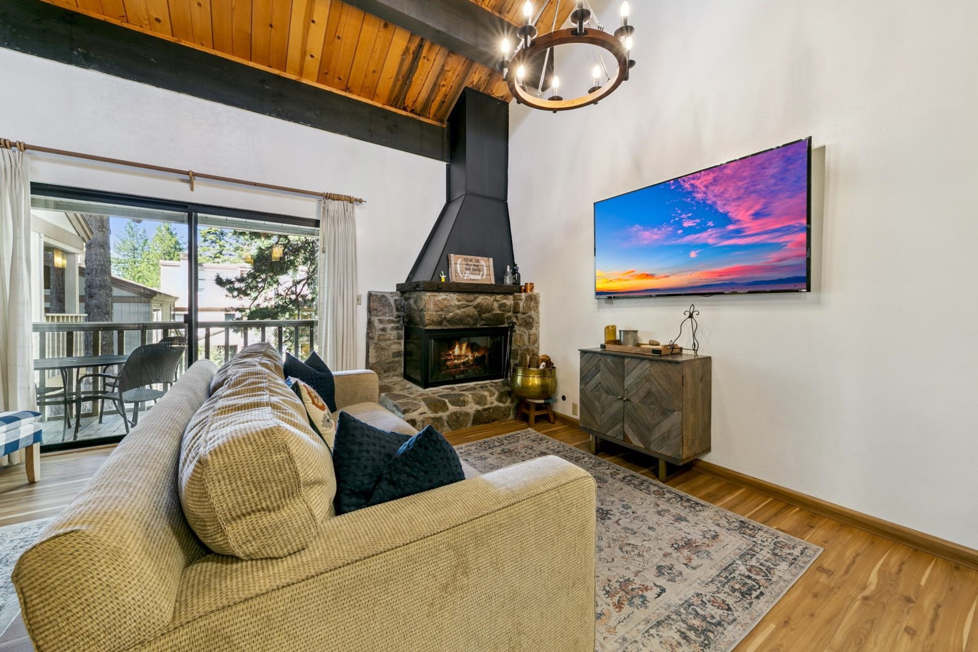 1001 Commonwealth Drive, Unit 114 Kings Beach, CA 96143 - Photo 4 of 23 a living room with furniture and a fireplace