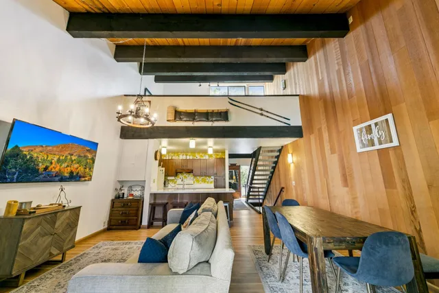 a living room with furniture and a painting on the wall