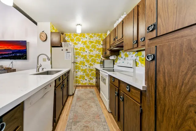 a kitchen with stainless steel appliances a sink and a refrigerator
