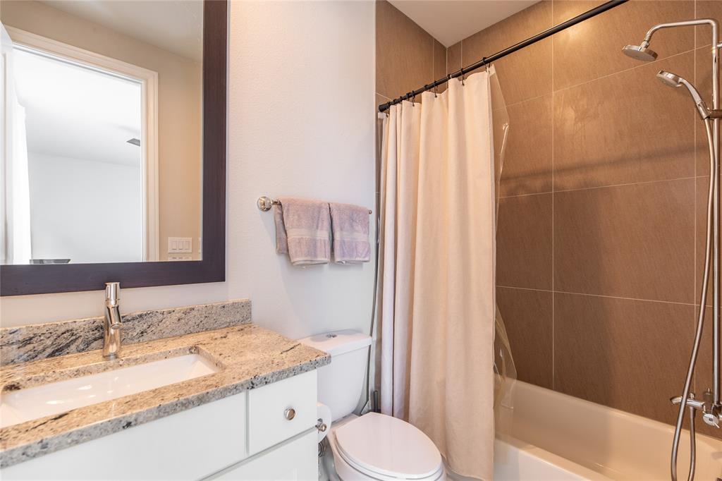 4116 Runyon Road Addison, TX 75001 - Photo 24 of 31 a bathroom with a granite countertop sink toilet and shower