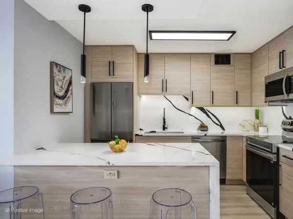 a kitchen with a sink a refrigerator and a stove