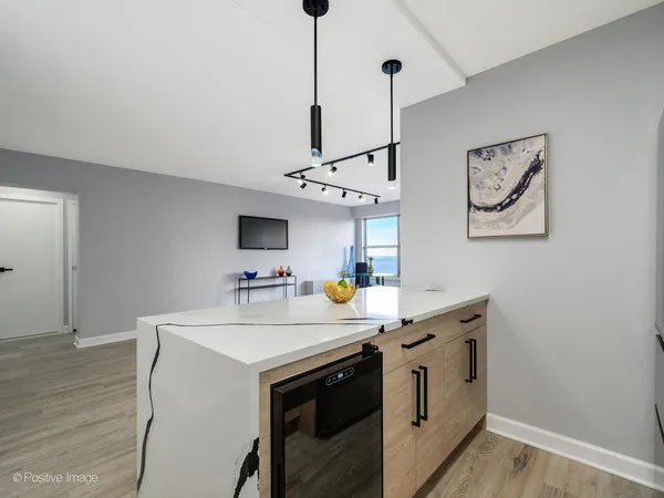 a kitchen with a sink a stove and a wooden floor