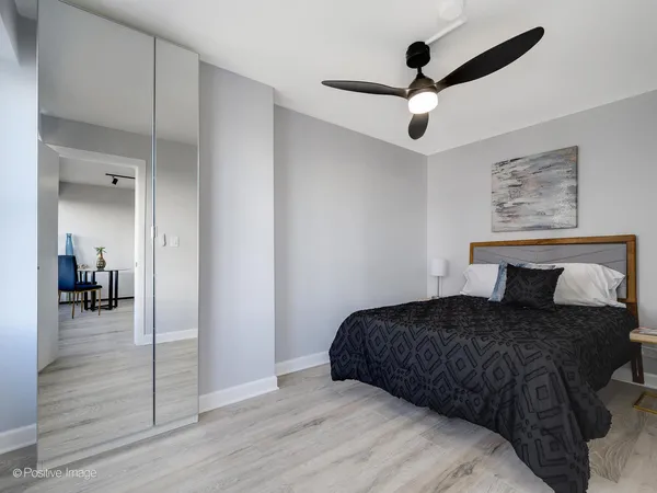 a bedroom with a bed and a chandelier