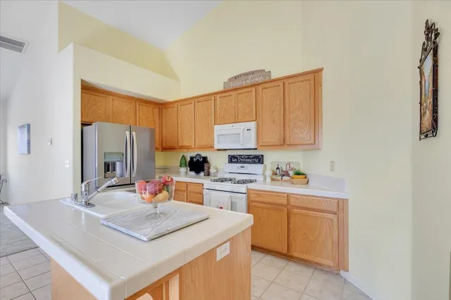 a large kitchen with stainless steel appliances granite countertop a stove and a sink