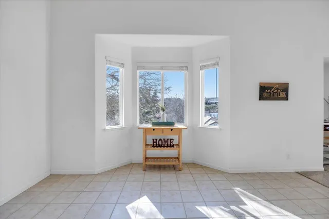a view of empty room with a fireplace and fan