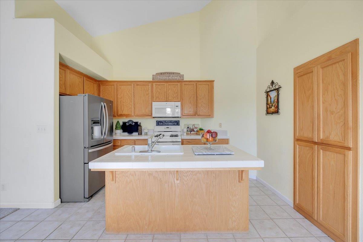 6250 Bluff View Road, Unit 60 Copperopolis, CA 95228 - Photo 19 of 75 a kitchen with stainless steel appliances granite countertop a refrigerator sink stove and microwave