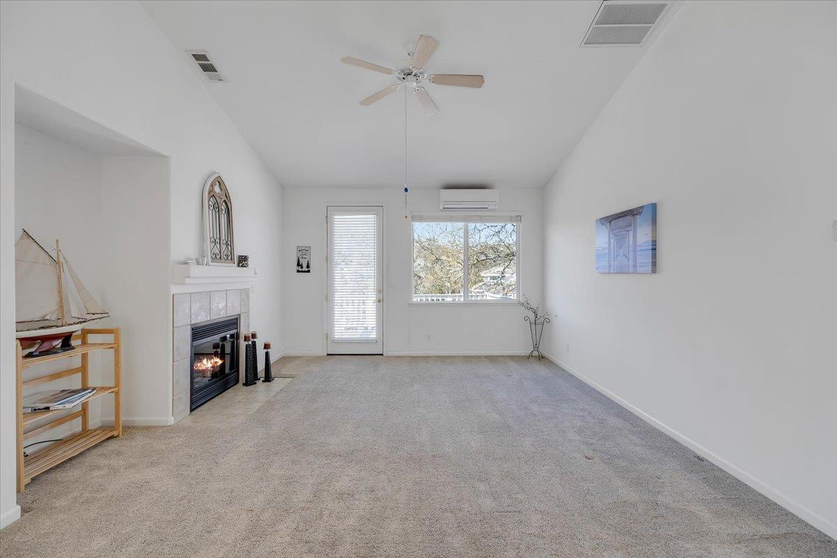 6250 Bluff View Road, Unit 60 Copperopolis, CA 95228 - Photo 21 of 75 an empty room with fireplace cabinet and windows
