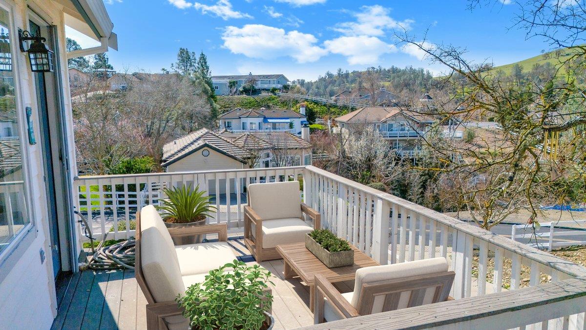 6250 Bluff View Road, Unit 60 Copperopolis, CA 95228 - Photo 22 of 75 a view of a balcony with couches and wooden floor