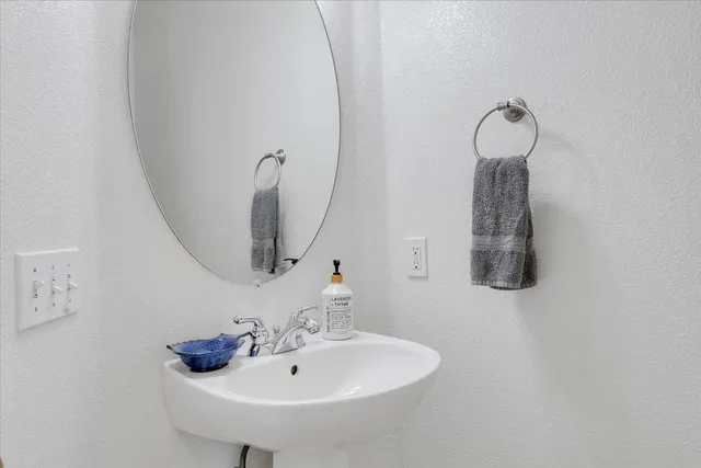 a bathroom with a sink vanity granite and toilet