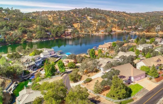 a view of a lake with houses in the back