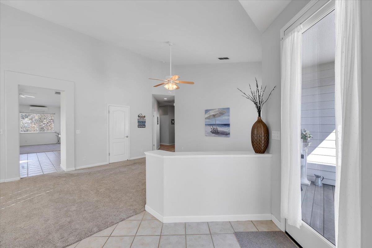 6250 Bluff View Road, Unit 60 Copperopolis, CA 95228 - Photo 7 of 75 a living room with a table and gym equipment