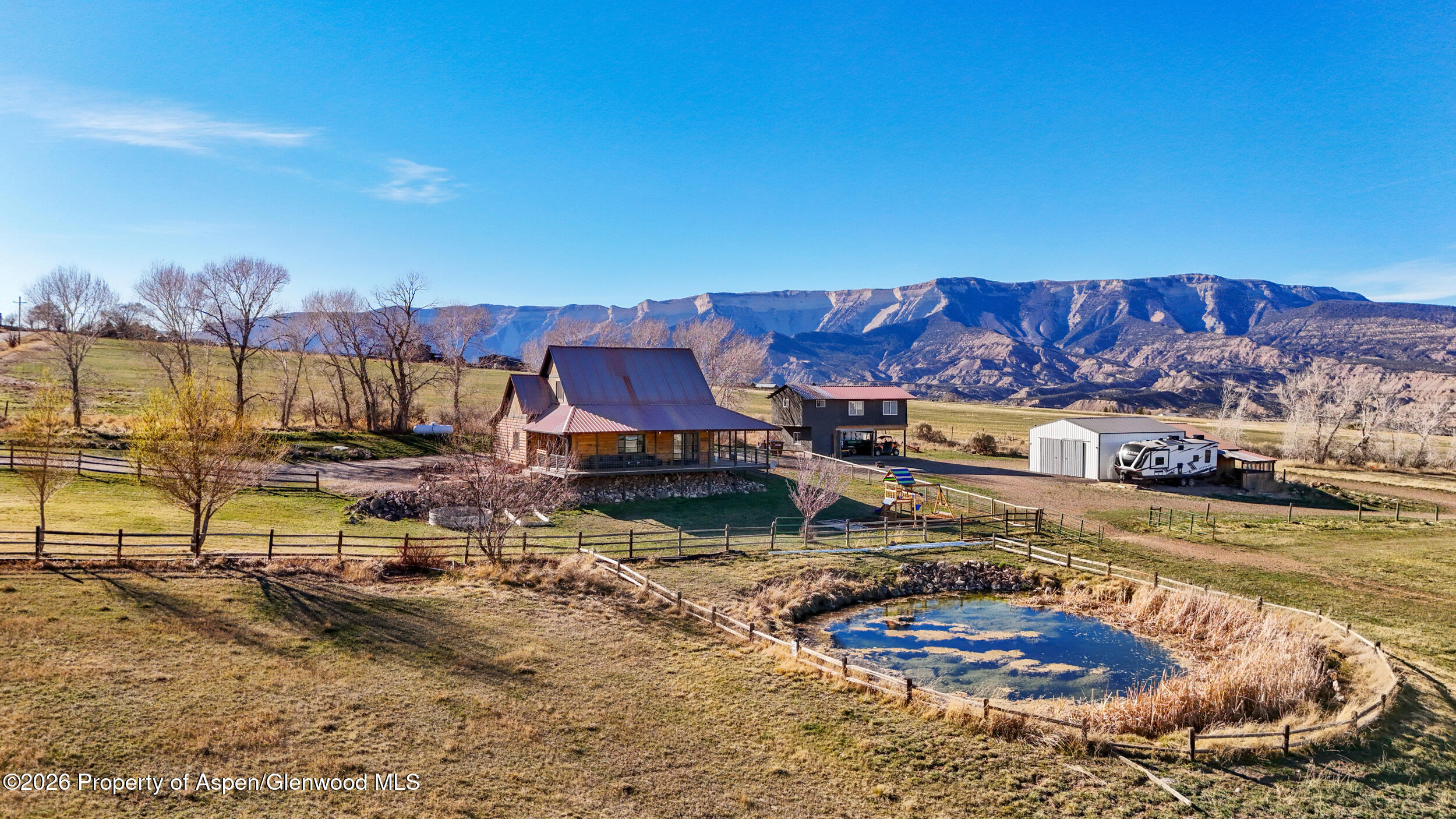 9109 County Road 320 Rifle, CO 81650 - Photo 2 of 38 a view of a swimming pool with a patio and a yard