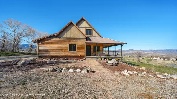 a front view of a house with yard patio and fire pit