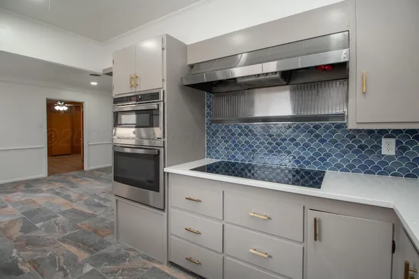 a kitchen with cabinets and stainless steel appliances