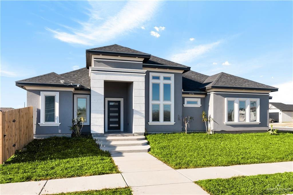 a front view of a house with a yard