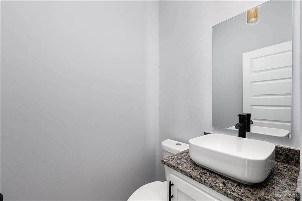 1271 Stirrup Circle San Benito, TX 78586 - Photo 11 of 18 a bathroom with a sink a toilet and mirror