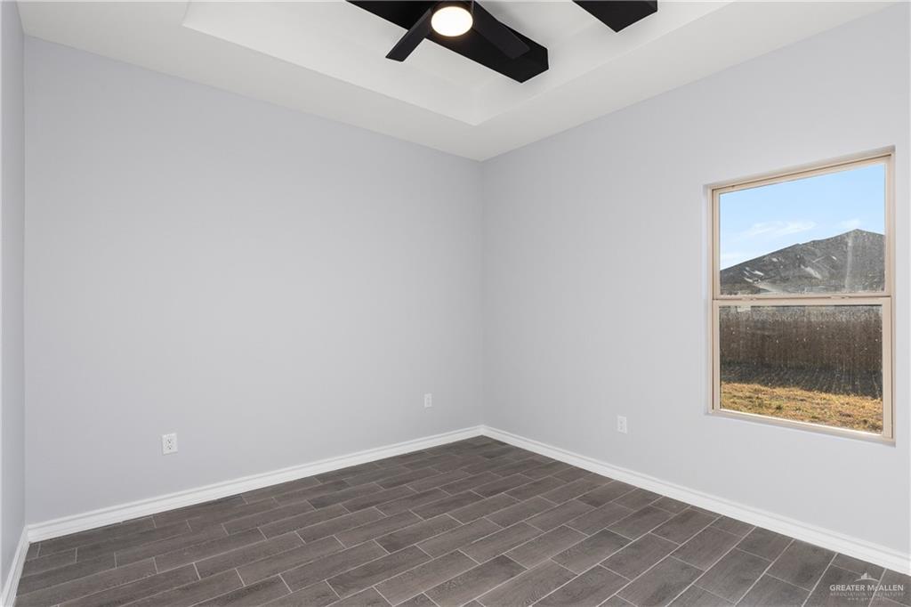 1271 Stirrup Circle San Benito, TX 78586 - Photo 12 of 18 wooden floor in an empty room with a window