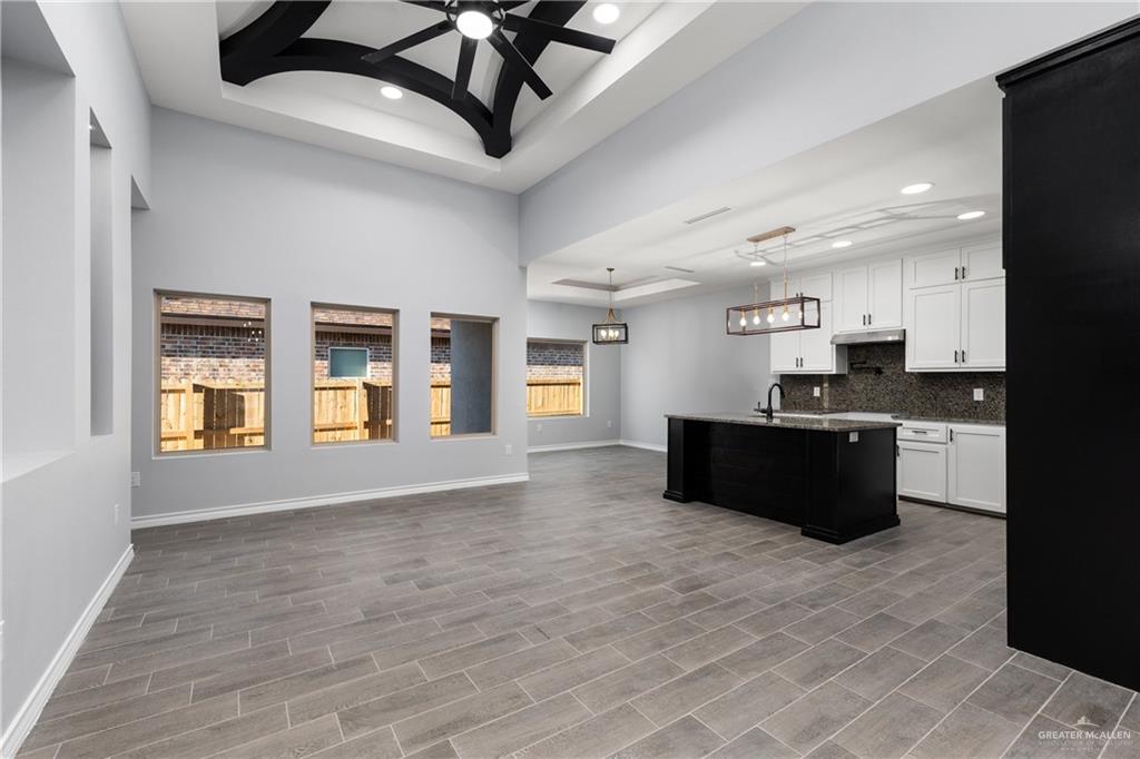 1271 Stirrup Circle San Benito, TX 78586 - Photo 18 of 18 a large kitchen with stainless steel appliances granite countertop a stove and a refrigerator
