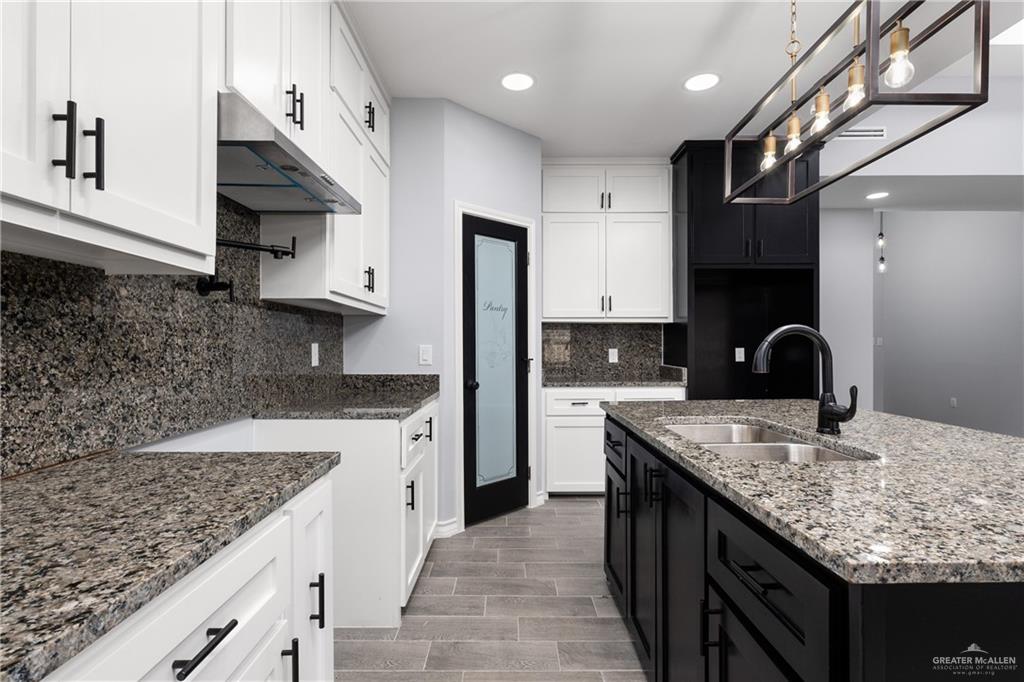 1271 Stirrup Circle San Benito, TX 78586 - Photo 2 of 18 a kitchen with granite countertop a sink stainless steel appliances and cabinets