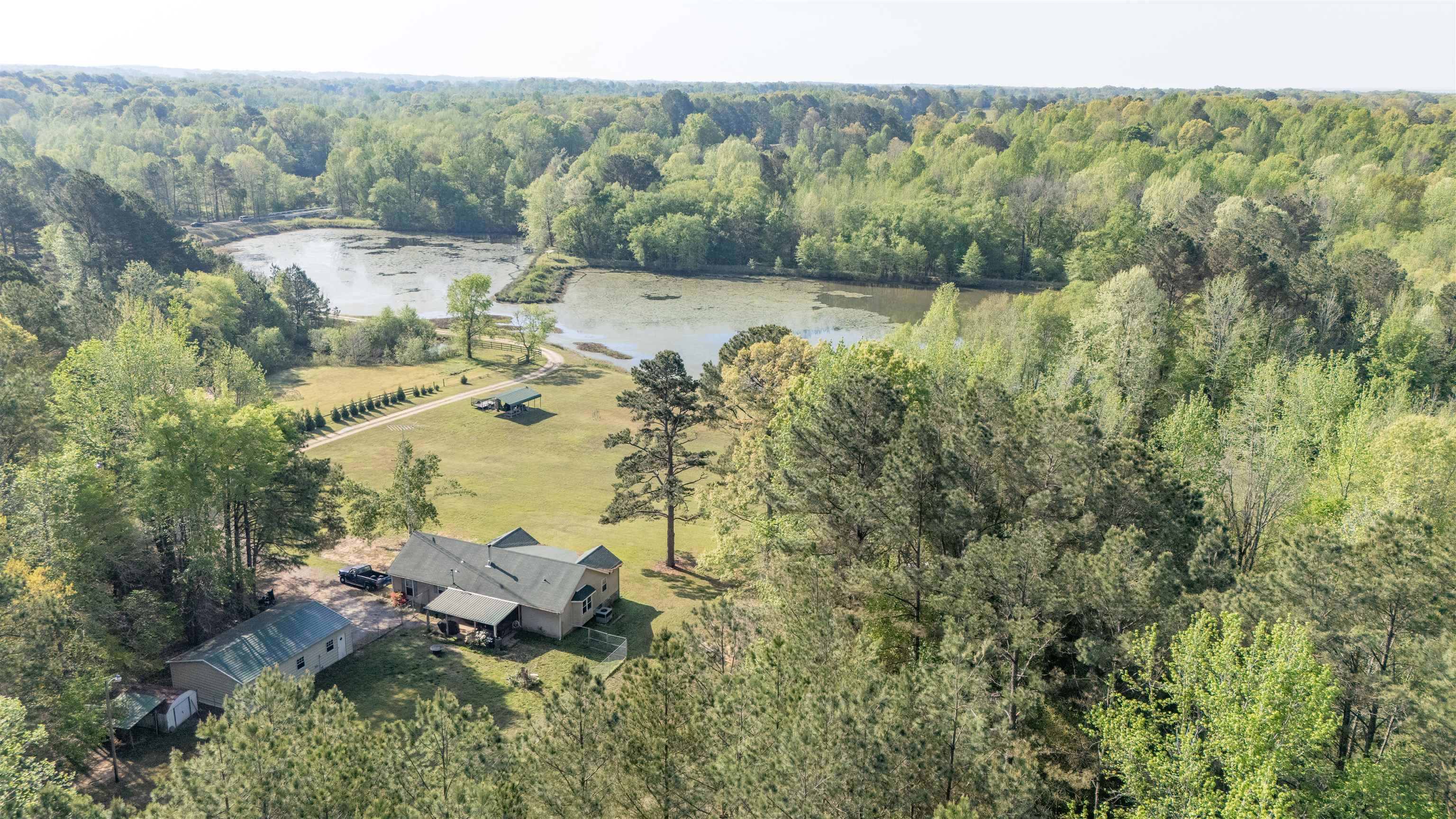 2551 Naylor Road Toone, TN 38381 - Photo 22 of 23 Drone / aerial view of a nearby body of water and a heavily wooded area