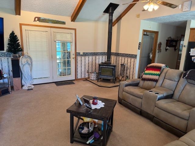 2551 Naylor Road Toone, TN 38381 - Photo 4 of 23 Carpeted living room featuring a wood stove, beam ceiling, and ceiling fan