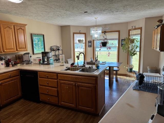 2551 Naylor Road Toone, TN 38381 - Photo 6 of 23 Kitchen with dark wood finished floors, light countertops, a peninsula, dishwasher, and a textured ceiling
