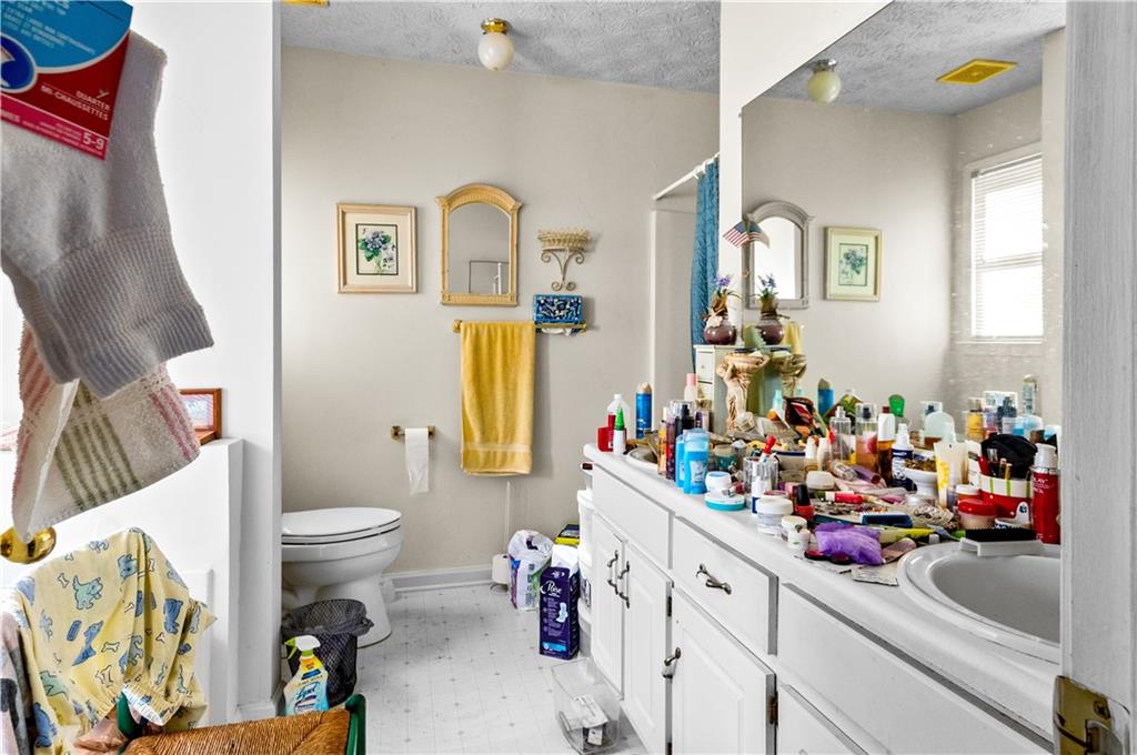 125 Laurel Way Covington, GA 30016 - Photo 17 of 21 a bathroom with a sink mirror vanity and toilet