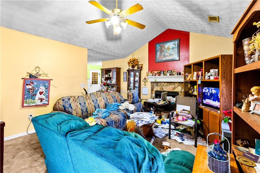 125 Laurel Way Covington, GA 30016 - Photo 8 of 21 a living room with lots of furniture and a flat screen tv