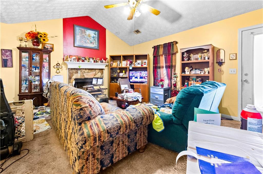 125 Laurel Way Covington, GA 30016 - Photo 9 of 21 a bedroom with bed and a fireplace