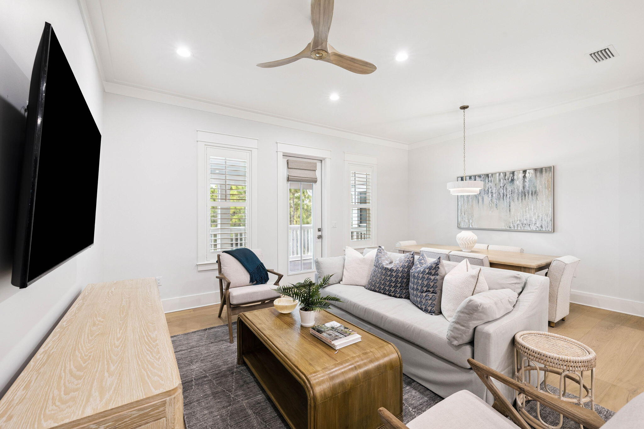 45 Grove Townhomes Place, Unit 101 Santa Rosa Beach, FL 32459 - Photo 10 of 36 a living room with furniture flat screen tv and a large window