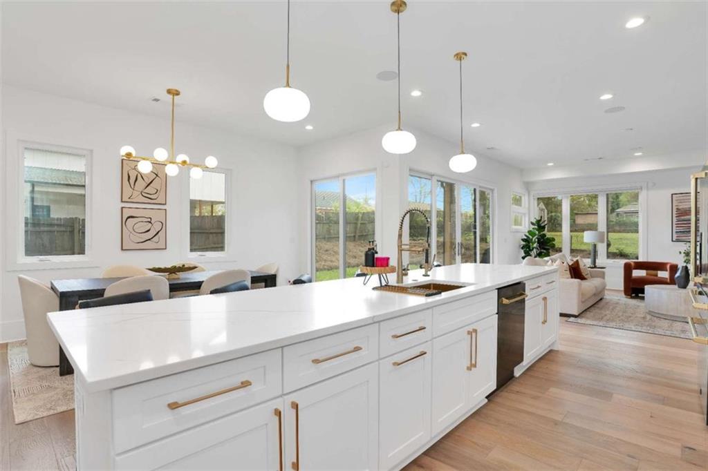 1598 Athens Avenue Southwest Atlanta, GA 30310 - Photo 13 of 45 a kitchen with center island a sink dishwasher a dining table chairs and a large window