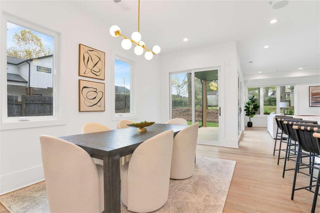 1598 Athens Avenue Southwest Atlanta, GA 30310 - Photo 14 of 45 a dining room with wooden floor a chandelier a wooden table and chairs