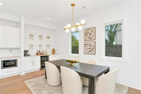 a view of a dining room with furniture and a chandelier