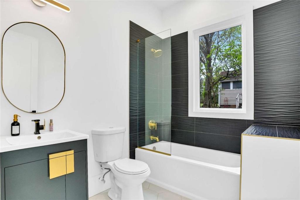 1598 Athens Avenue Southwest Atlanta, GA 30310 - Photo 21 of 45 a bathroom with a sink a bathtub and a mirror