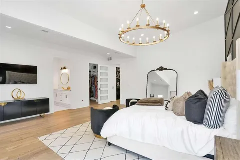 a bedroom with a bed and a flat screen tv