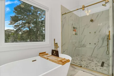 a white bath tub sitting next to a window