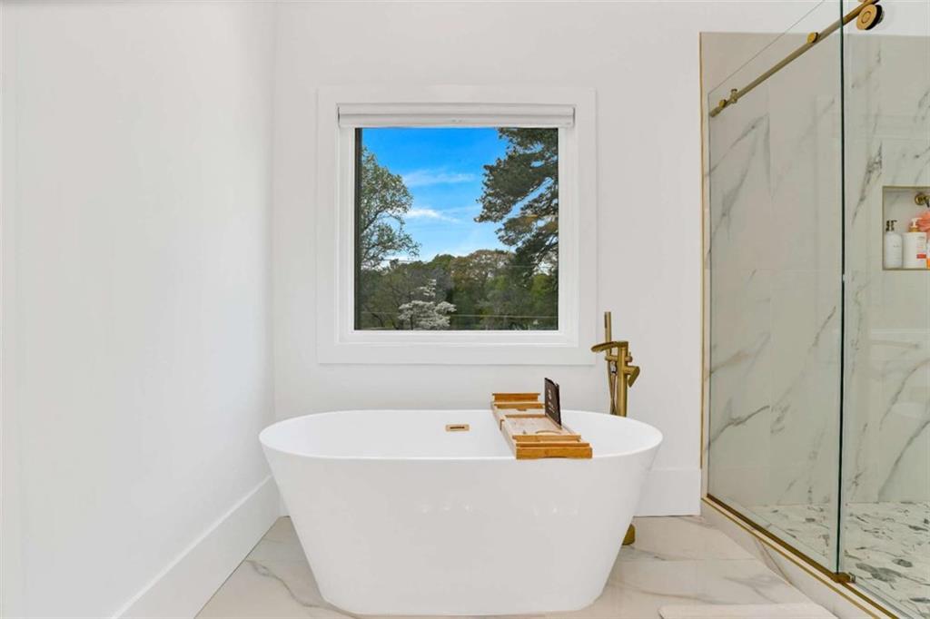 1598 Athens Avenue Southwest Atlanta, GA 30310 - Photo 34 of 45 a white bath tub sitting next to a window