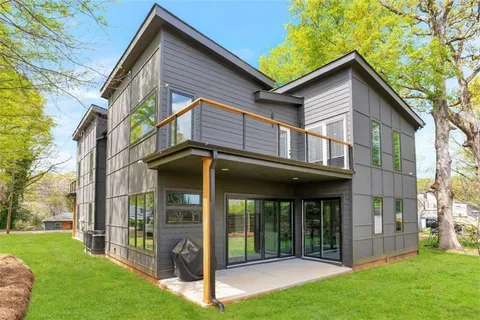 a view of a porch with furniture and garden
