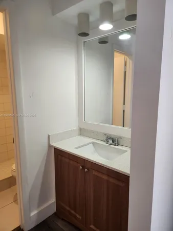 a bathroom with a shower and a sink