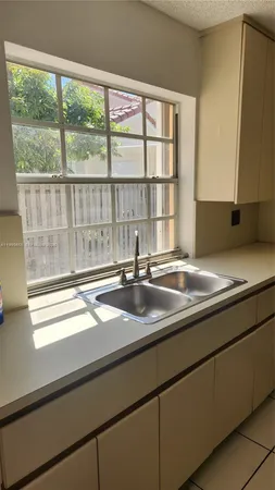 a kitchen with a sink and a window