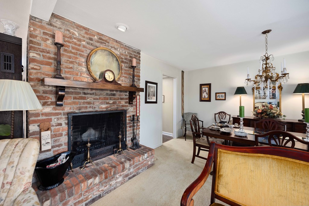 13965 Cross Creek Road Upatoi, GA 31829 - Photo 12 of 44 a living room with furniture a flat screen tv and a fireplace