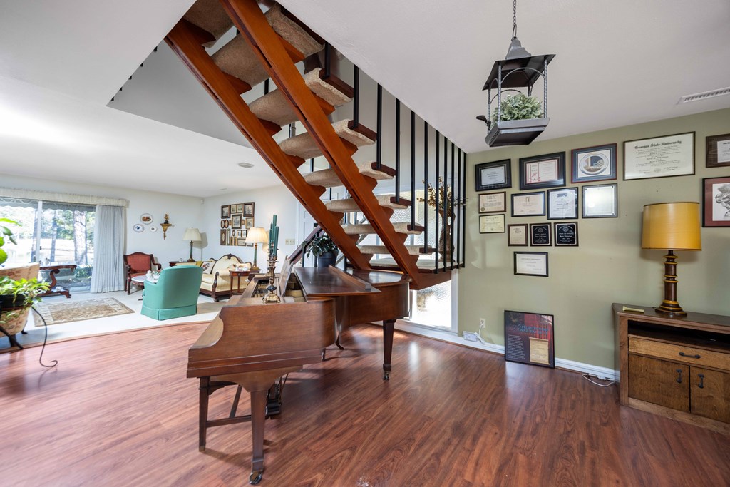 13965 Cross Creek Road Upatoi, GA 31829 - Photo 14 of 44 a living room with furniture and a wooden floor