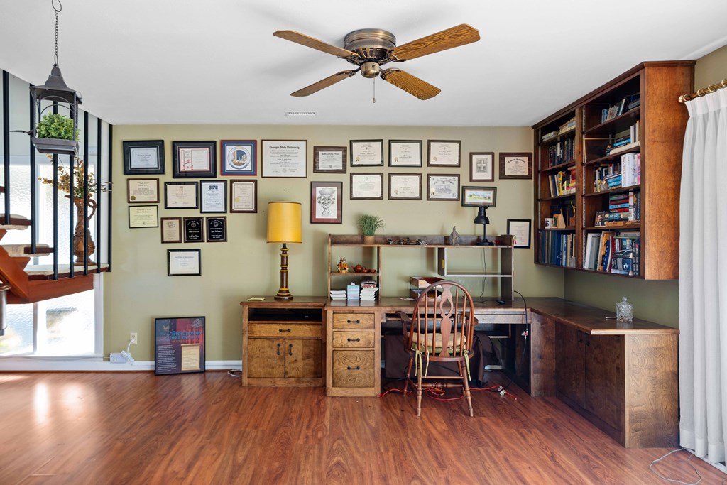 13965 Cross Creek Road Upatoi, GA 31829 - Photo 15 of 44 a work room with furniture and wooden floor