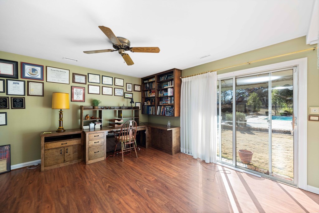 13965 Cross Creek Road Upatoi, GA 31829 - Photo 16 of 44 a view of a workspace with furniture window and wooden floor