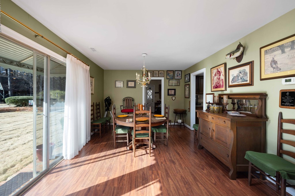 13965 Cross Creek Road Upatoi, GA 31829 - Photo 17 of 44 a living room with furniture a wooden floor and next to a window