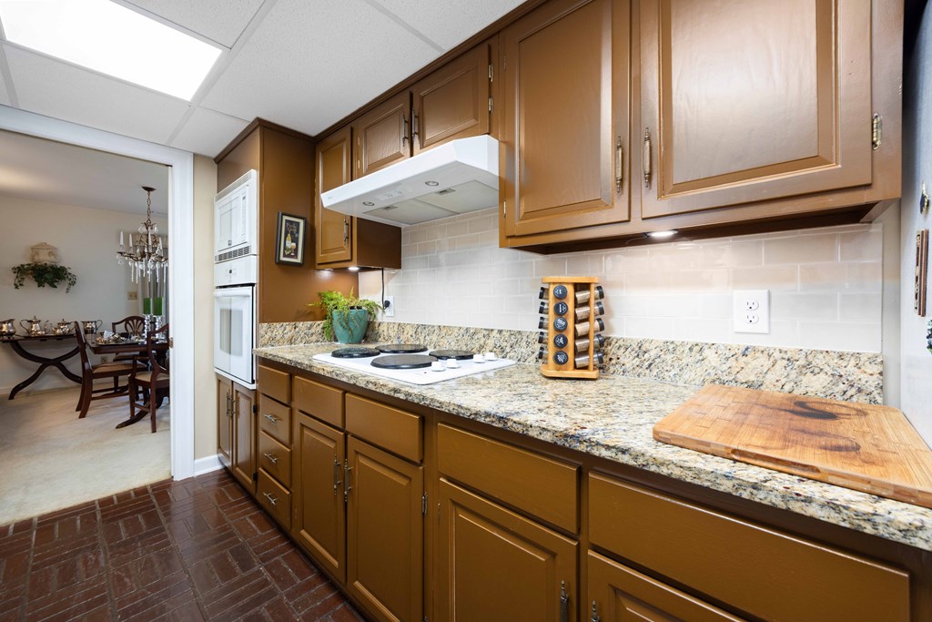 13965 Cross Creek Road Upatoi, GA 31829 - Photo 18 of 44 a kitchen with stainless steel appliances granite countertop a sink stove and cabinets