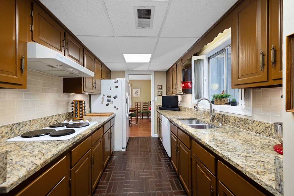 13965 Cross Creek Road Upatoi, GA 31829 - Photo 21 of 44 a kitchen with stainless steel appliances granite countertop a sink stove and refrigerator