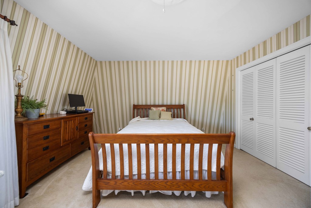 13965 Cross Creek Road Upatoi, GA 31829 - Photo 27 of 44 a bedroom with a bed and a mirror